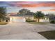 White single story home with attached garage at sunset at 1045 Carter Rd, Deland, FL 32724