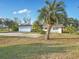 Ranch style home with palm tree and large driveway at 1045 Carter Rd, Deland, FL 32724