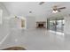 Open living area with tile floors, corner fireplace and access to lanai at 1045 Carter Rd, Deland, FL 32724