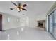 Large living room with tile floors, fireplace and access to outdoor space at 1045 Carter Rd, Deland, FL 32724