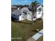 Aerial view of a single-Gathering home with a large yard and palm trees at 105 Barrier Isle Dr, Ormond Beach, FL 32176