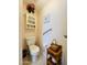 Clean bathroom with toilet, small vanity, and grab bar at 105 Barrier Isle Dr, Ormond Beach, FL 32176