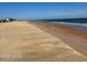 Beachfront view with ocean waves and sandy shore at 105 Barrier Isle Dr, Ormond Beach, FL 32176