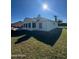 Rear view of a single-story home with a sunroom at 105 Barrier Isle Dr, Ormond Beach, FL 32176