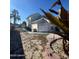 Backyard view showing exterior of house, landscaping, and a partial view of the pool at 105 Barrier Isle Dr, Ormond Beach, FL 32176