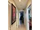 Long hallway with artwork and view into bedrooms at 105 Barrier Isle Dr, Ormond Beach, FL 32176