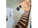 Staircase with wooden steps and railing at 105 Barrier Isle Dr, Ormond Beach, FL 32176