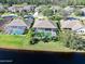 Aerial view of homes with private pools near a lake at 1221 Harwick Ln, Ormond Beach, FL 32174