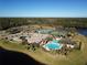 Aerial view of community pool, tennis courts, and lake at 1311 Hansberry Ln, Ormond Beach, FL 32174