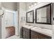 Double vanity bathroom with dark brown cabinets and mirrors at 1311 Hansberry Ln, Ormond Beach, FL 32174