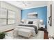 Main bedroom with a king-size bed and blue accent wall at 1311 Hansberry Ln, Ormond Beach, FL 32174