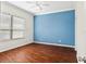 Bright bedroom with hardwood floors and blue accent wall at 1311 Hansberry Ln, Ormond Beach, FL 32174