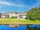 Tan house with screened porch, overlooking a tranquil lake at 1311 Hansberry Ln, Ormond Beach, FL 32174