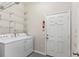 Laundry room with washer, dryer, and ample shelving at 1311 Hansberry Ln, Ormond Beach, FL 32174