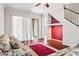 Living room with floral sofas, red rug, and access to backyard at 1311 Hansberry Ln, Ormond Beach, FL 32174