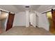 Spacious bedroom with carpeted floors and two barn doors at 141 Kingston Ave, Daytona Beach, FL 32114