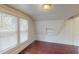 Well-lit bedroom with hardwood floors and built-in shelves at 141 Kingston Ave, Daytona Beach, FL 32114