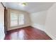 Bright bedroom with hardwood floors and two windows at 141 Kingston Ave, Daytona Beach, FL 32114