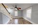 Upstairs hallway with wood floors and neutral walls at 141 Kingston Ave, Daytona Beach, FL 32114