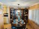 Cozy dining area with a wooden table and view into the kitchen at 215 Rue De Paresse, Tavares, FL 32778