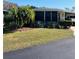 Landscaped mobile home with covered carport and spacious yard at 215 Rue De Paresse, Tavares, FL 32778