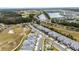 Aerial perspective of townhouses nestled near a golf course and serene lake at 2840 Isles Way, New Smyrna Beach, FL 32168