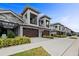 Row of townhouses with dark brown garage doors and manicured landscaping at 2840 Isles Way, New Smyrna Beach, FL 32168