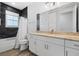 Modern bathroom with dark tile, granite countertop, and white cabinets at 2840 Isles Way, New Smyrna Beach, FL 32168