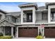 Contemporary townhome showcasing a dark brown garage door and balcony at 2840 Isles Way, New Smyrna Beach, FL 32168