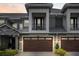 Modern two-story townhome with a dark brown garage door and balcony at 2840 Isles Way, New Smyrna Beach, FL 32168