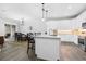 Modern white kitchen with granite island and stainless steel appliances at 2840 Isles Way, New Smyrna Beach, FL 32168