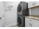 Stackable washer and dryer in a bright laundry room at 2840 Isles Way, New Smyrna Beach, FL 32168