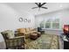 Living room with comfy seating, large windows, and ceiling fan at 2840 Isles Way, New Smyrna Beach, FL 32168