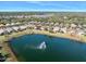 Aerial view of community with lake and fountain at 3189 Connemara Dr, Ormond Beach, FL 32174