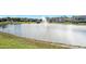 Serene lake view with a water fountain in a residential community at 3189 Connemara Dr, Ormond Beach, FL 32174