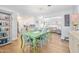 Charming dining room with light green table and colorful chairs at 35 Country Club Dr, Ormond Beach, FL 32176