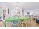 Bright dining room featuring a light green table and mismatched chairs at 35 Country Club Dr, Ormond Beach, FL 32176