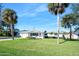 Single story home with palm trees and green lawn at 35 Country Club Dr, Ormond Beach, FL 32176