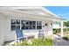 Inviting front porch with rocking chairs and pink door at 35 Country Club Dr, Ormond Beach, FL 32176