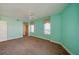 Spacious bedroom with light teal walls and carpeted floors at 4565 S Atlantic Ave # 5601, Port Orange, FL 32127