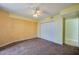 Bedroom featuring carpet, neutral walls, and a ceiling fan at 4565 S Atlantic Ave # 5601, Port Orange, FL 32127