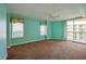 Primary bedroom with light teal walls and carpeted floors at 4565 S Atlantic Ave # 5601, Port Orange, FL 32127