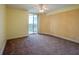 Bright bedroom with carpet flooring and balcony access at 4565 S Atlantic Ave # 5601, Port Orange, FL 32127