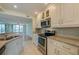 Bright kitchen boasts stainless steel appliances and granite counters at 4565 S Atlantic Ave # 5601, Port Orange, FL 32127