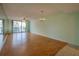 Light and airy living room with hardwood floors and balcony access at 4565 S Atlantic Ave # 5601, Port Orange, FL 32127