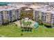 Aerial view of condo building with pool and lush landscaping at 4670 Links Village Dr # B201, Ponce Inlet, FL 32127