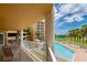 Relaxing balcony with pool and partial ocean view at 4670 Links Village Dr # B201, Ponce Inlet, FL 32127