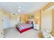 Bedroom with striped bedding, an armchair and access to the bathroom at 4670 Links Village Dr # B201, Ponce Inlet, FL 32127