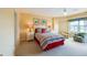 Bright bedroom with colorful bedding and a comfortable armchair at 4670 Links Village Dr # B201, Ponce Inlet, FL 32127