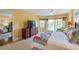 Spacious main bedroom with a large bed, dresser, and access to a balcony at 4670 Links Village Dr # B201, Ponce Inlet, FL 32127